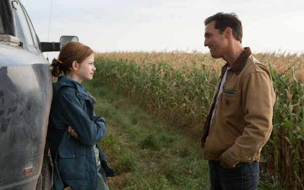 HD wallpaper featuring a scene from the movie Interstellar, depicting a father and daughter having a conversation beside a truck with a cornfield in the background.