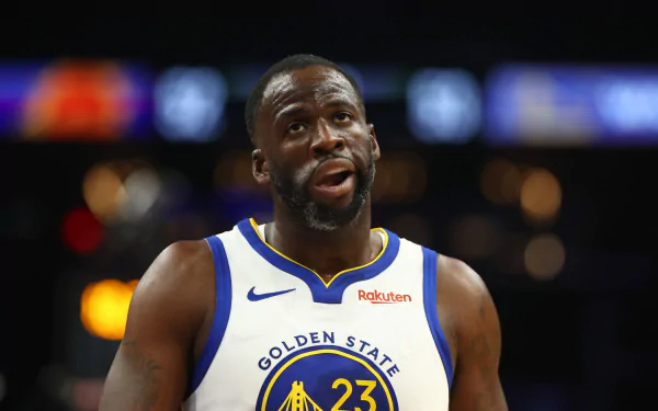 Draymond Green of the Golden State Warriors is featured in this HD desktop wallpaper, showcasing his intense focus during a game.
