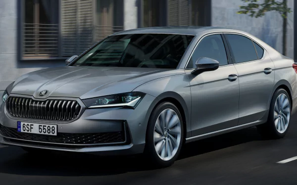 Silver Škoda Superb car HD wallpaper with clean modern design parked on an urban street.