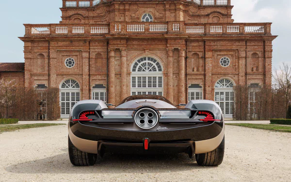 A Pagani Huayra parked in front of an elegant historic building, serving as an HD desktop wallpaper.