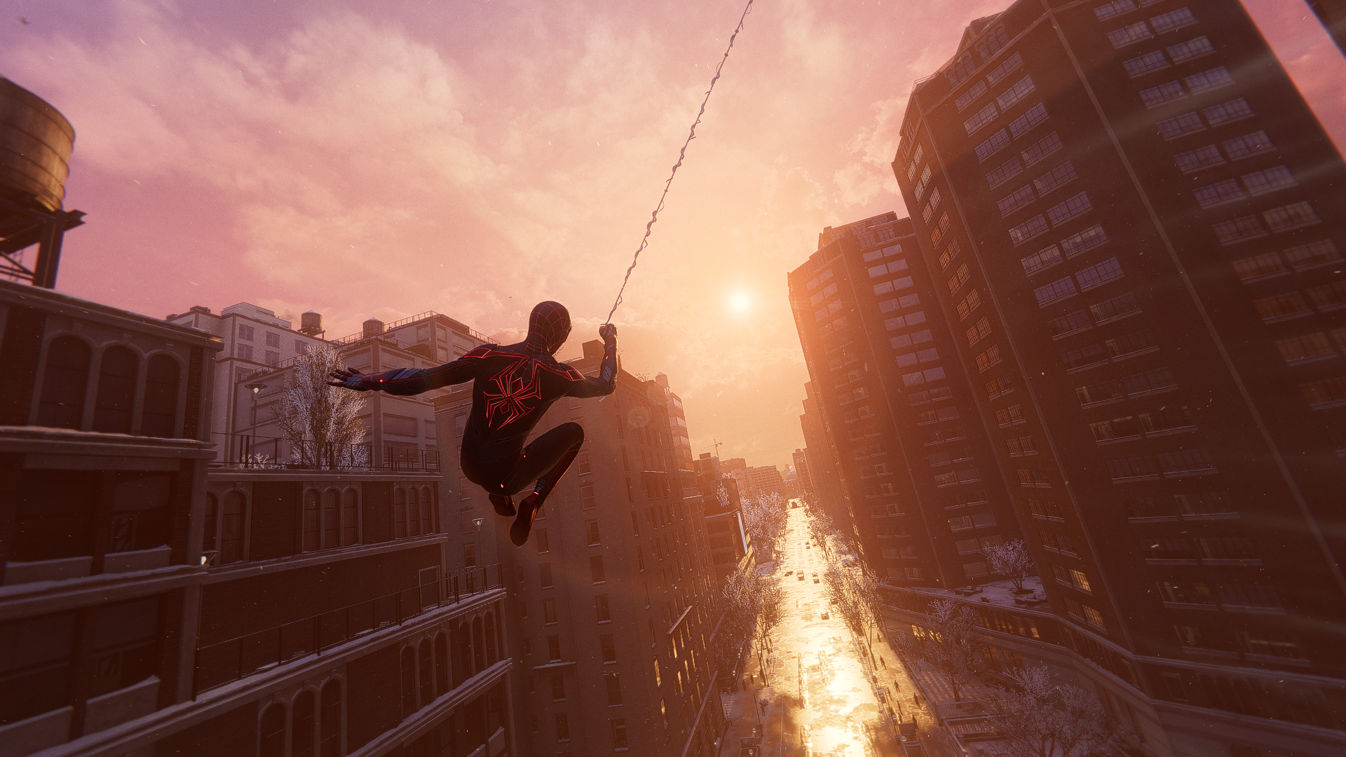 HD PC desktop wallpaper of Spider-Man from the PlayStation video game, swinging on a web above a sunlit city street at sunset.