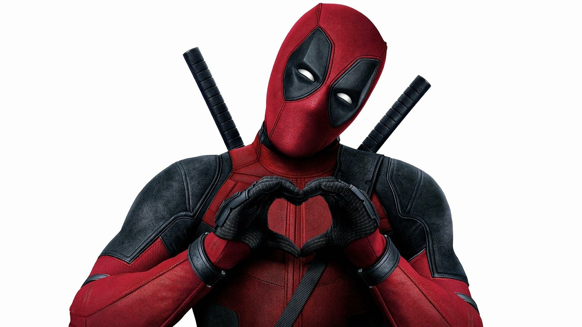 HD PC desktop wallpaper featuring Marvel Comics' Deadpool, portrayed by Ryan Reynolds, making a heart shape with his hands.