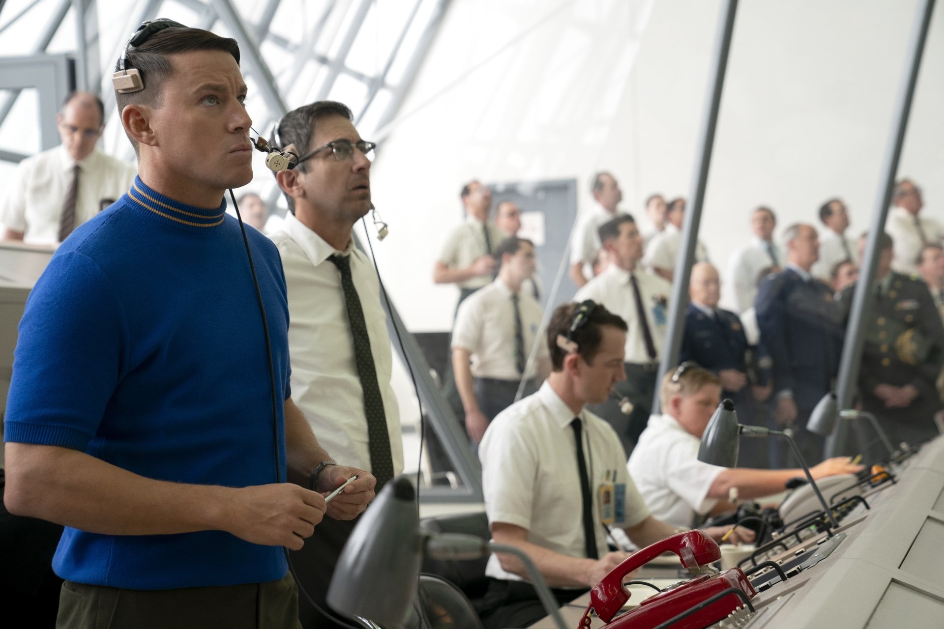 HD desktop wallpaper featuring Channing Tatum in a scene from Fly Me to the Moon (2024), showcasing a busy control room with several men wearing headsets and focused on their tasks.