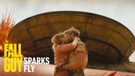 HD desktop wallpaper of The Fall Guy featuring a man and woman embracing in front of a large, circular structure with the tagline SPARKS FLY.