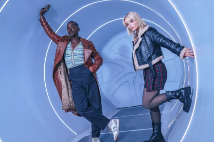 HD desktop wallpaper featuring Ncuti Gatwa and a co-star striking dynamic poses with a futuristic backdrop, from the 2023 series of Doctor Who.