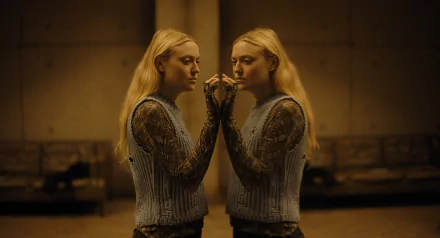 HD wallpaper featuring Dakota Fanning in The Watchers (2024). The image showcases a symmetrical reflection of her, creating a captivating visual. The background has a warm, dimly lit ambiance.