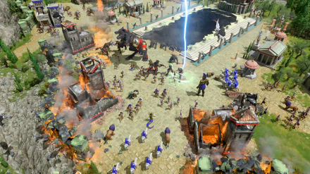 HD desktop wallpaper featuring a vibrant battle scene from the video game Age of Mythology: Retold, showcasing mythical creatures, ancient soldiers, and burning towers.