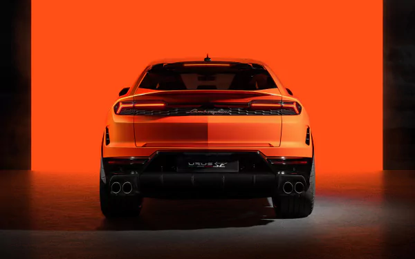 HD desktop wallpaper of a Lamborghini Urus set against a vibrant orange background, highlighting the car's sleek rear silhouette and distinctive taillights.