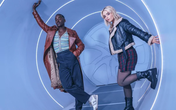 HD desktop wallpaper featuring Ncuti Gatwa and a co-star striking dynamic poses with a futuristic backdrop, from the 2023 series of Doctor Who.