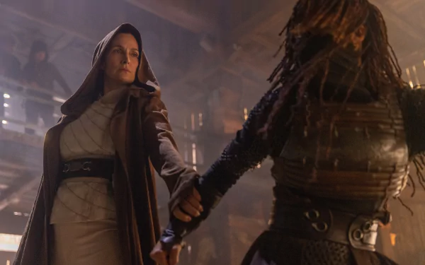A HD desktop wallpaper and background from the TV show The Acolyte (2024), depicting a dramatic scene with two characters in intense combat within a dimly lit environment.