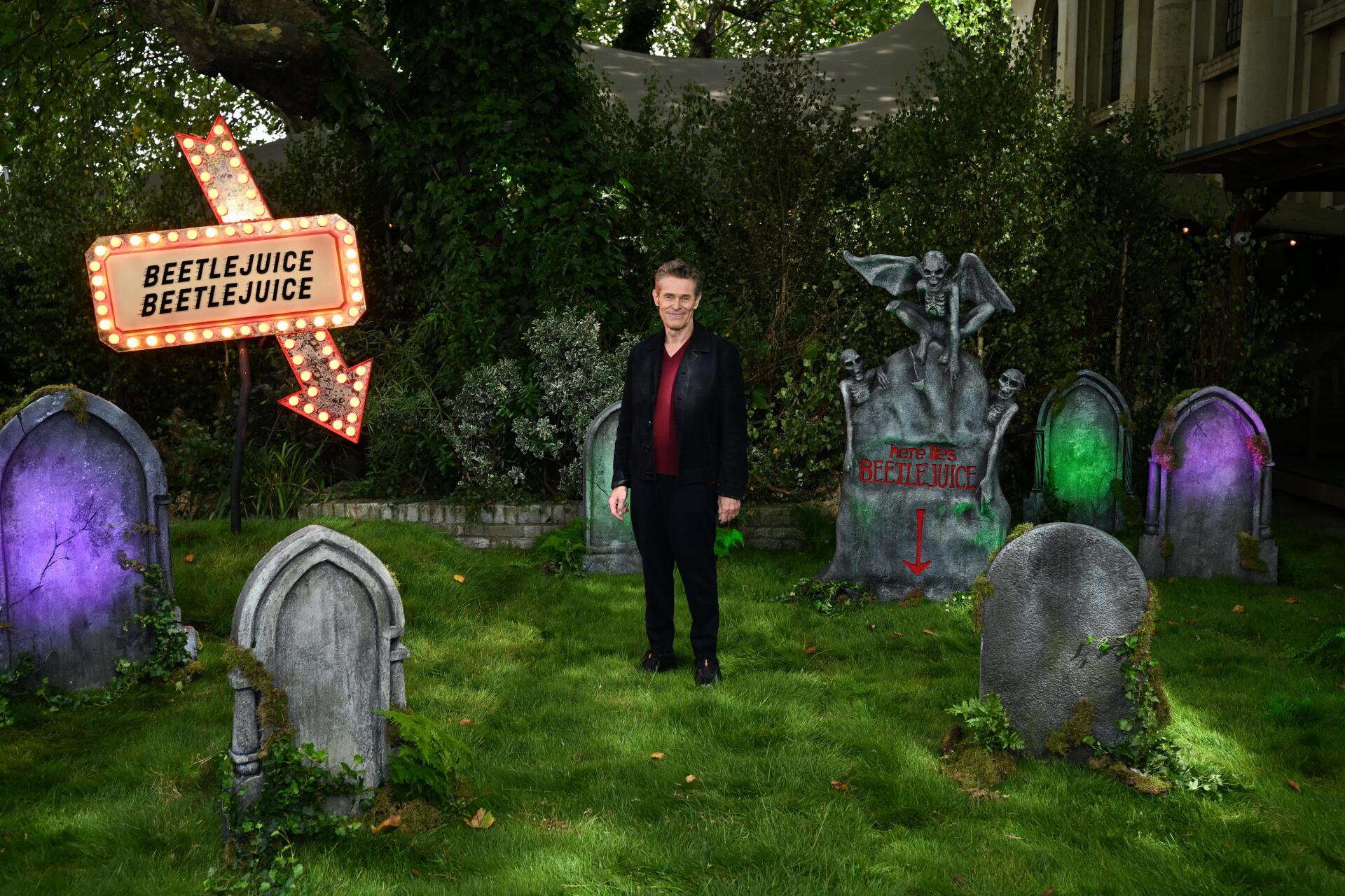 An 8K Ultra HD wallpaper featuring elements from the movie Beetlejuice, featuring Willem Dafoe, showcasing a vibrant and eerie aesthetic.
