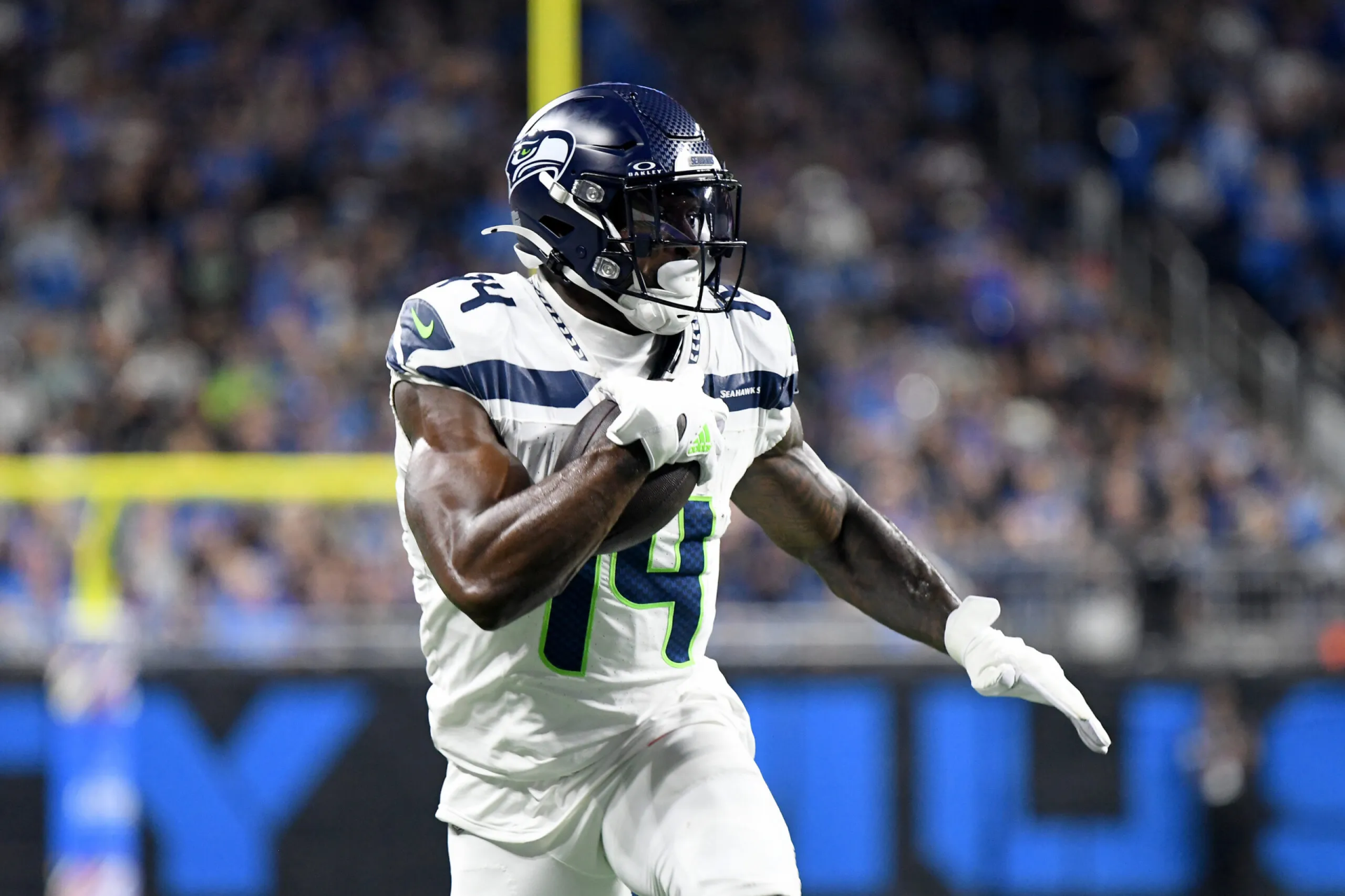 DK Metcalf of the Seattle Seahawks celebrates during an NFL game, showcasing his agility and athleticism on the field. A dynamic sports-themed HD desktop wallpaper.