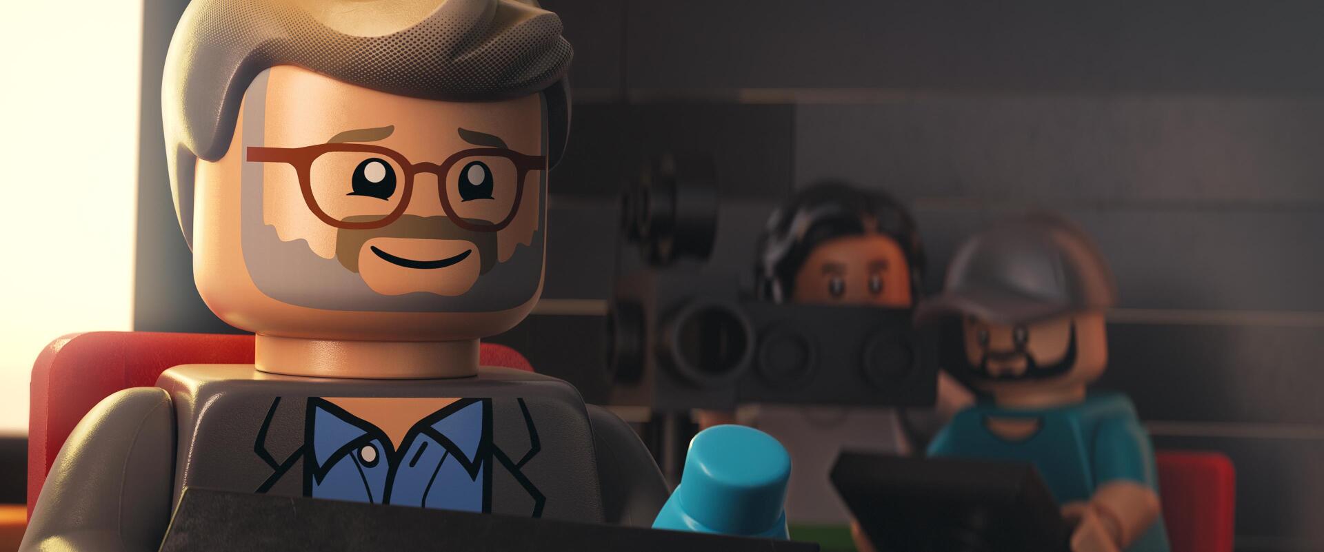 A colorful HD desktop wallpaper from the movie Piece by Piece, featuring LEGO characters, including a smiling figure with glasses, set against a cinematic backdrop.
