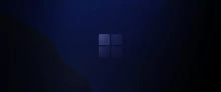 HD PC desktop wallpaper featuring a dark blue background with a subtle, illuminated Windows logo centered.