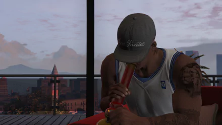 HD PC desktop wallpaper featuring Franklin from Grand Theft Auto V, sitting indoors with cityscape visible through large windows at dusk.