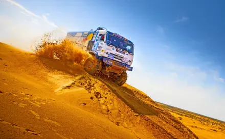 A dynamic HD wallpaper featuring a Kamaz off-road truck adorned with Red Bull branding, showcasing rugged performance in an adventurous setting.