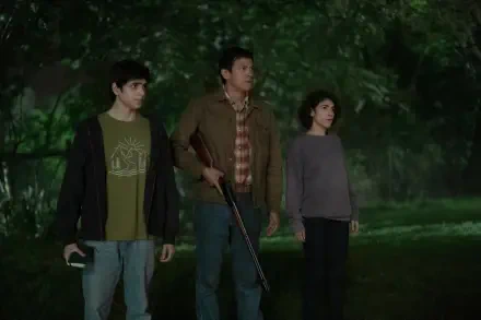 A still from the TV show Teacup (2024), featuring three characters in a dimly lit, wooded setting, conveying a sense of tension and anticipation. This 8K Ultra HD image serves as a striking desktop wallpaper.