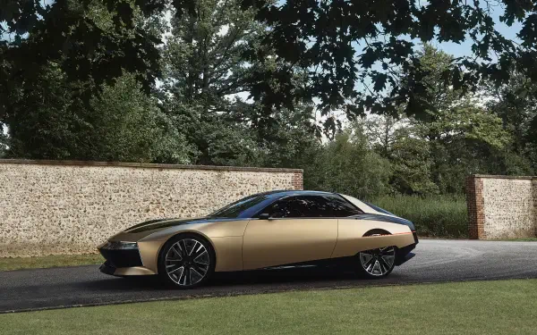 A sleek DS SM Tribute car parked beside a stone wall under trees, captured in a 4K Ultra HD PC desktop wallpaper and background.