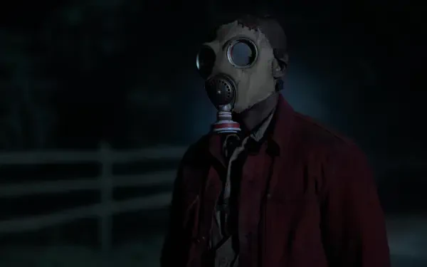 A mysterious figure in a gas mask stands in a dark setting, embodying the eerie atmosphere of the TV show Teacup (2024). Captured in stunning 8K Ultra HD detail.