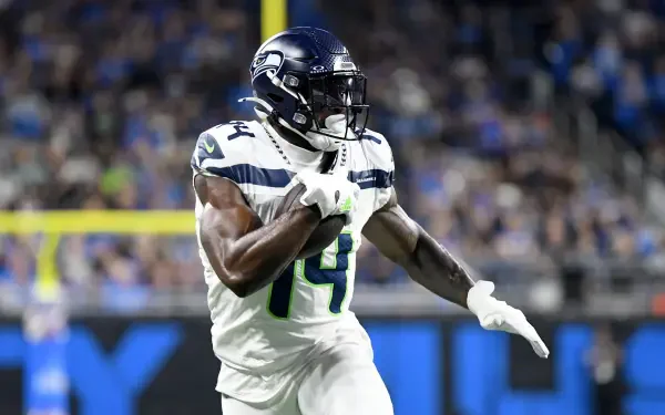 DK Metcalf of the Seattle Seahawks celebrates during an NFL game, showcasing his agility and athleticism on the field. A dynamic sports-themed HD desktop wallpaper.
