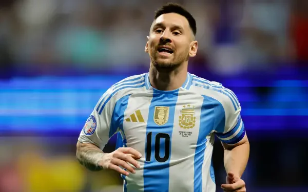 Lionel Messi celebrates on the field, wearing the Argentina National Football Team jersey. A vibrant action shot capturing the spirit of soccer in stunning 4K Ultra HD.
