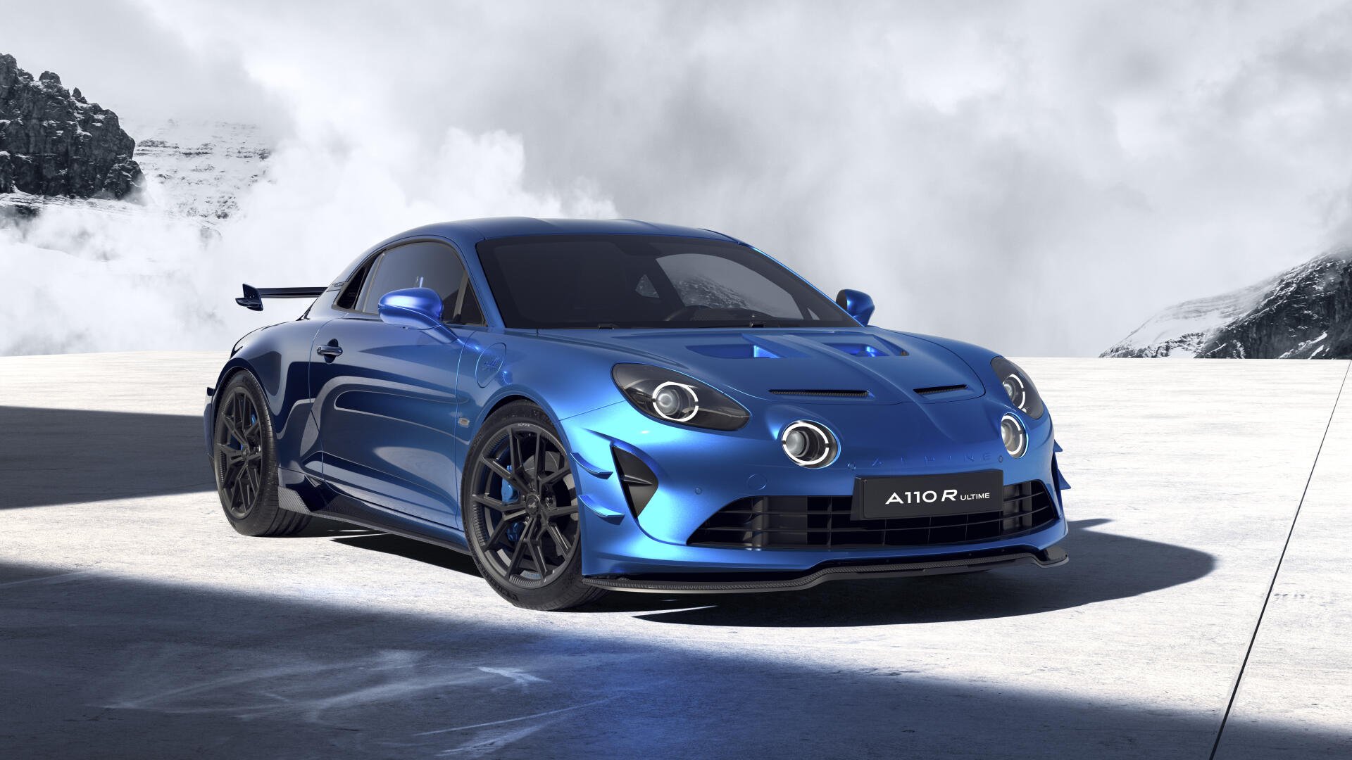 A sleek blue Alpine A110 R Ultime sports car showcased on a snowy mountain backdrop, rendered in 4K Ultra HD for a striking PC desktop wallpaper.
