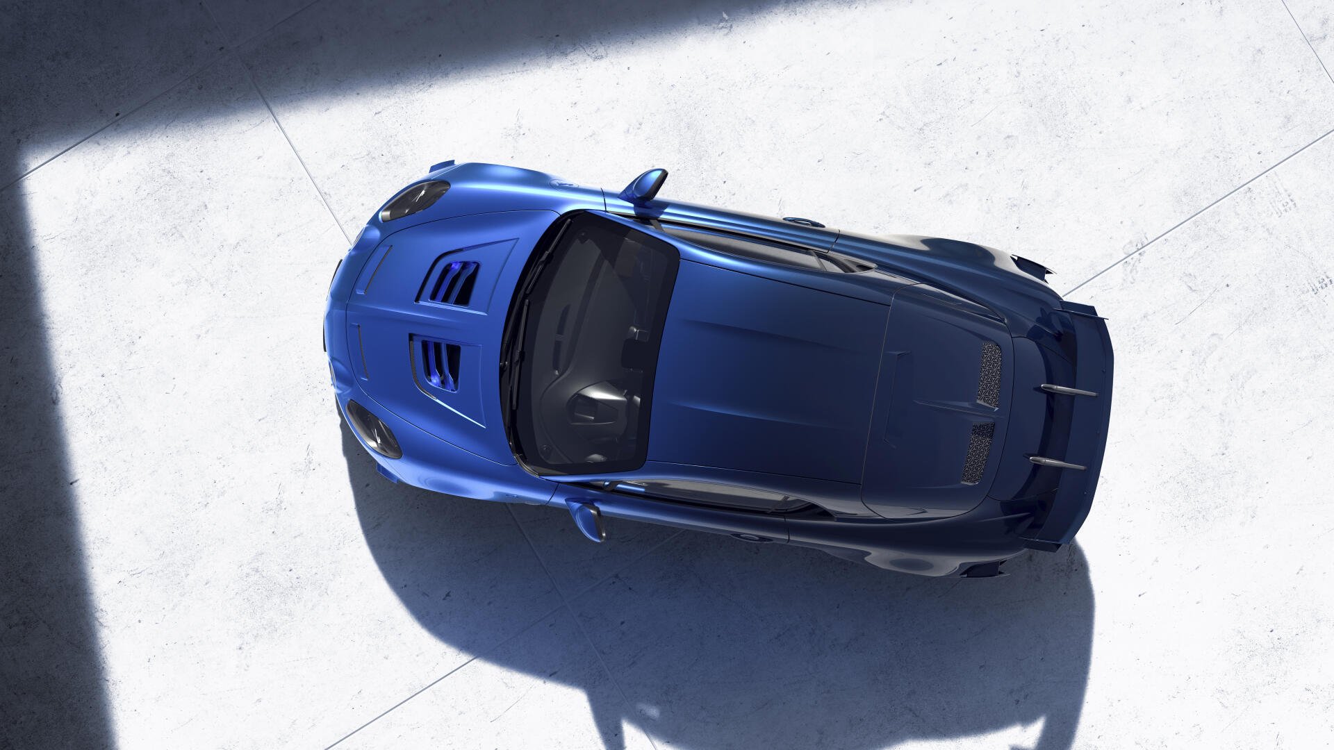 An overhead view of a striking blue Alpine A110 R Ultime, showcased in a clean, modern setting, captured in stunning 4K Ultra HD resolution for a dynamic desktop wallpaper.
