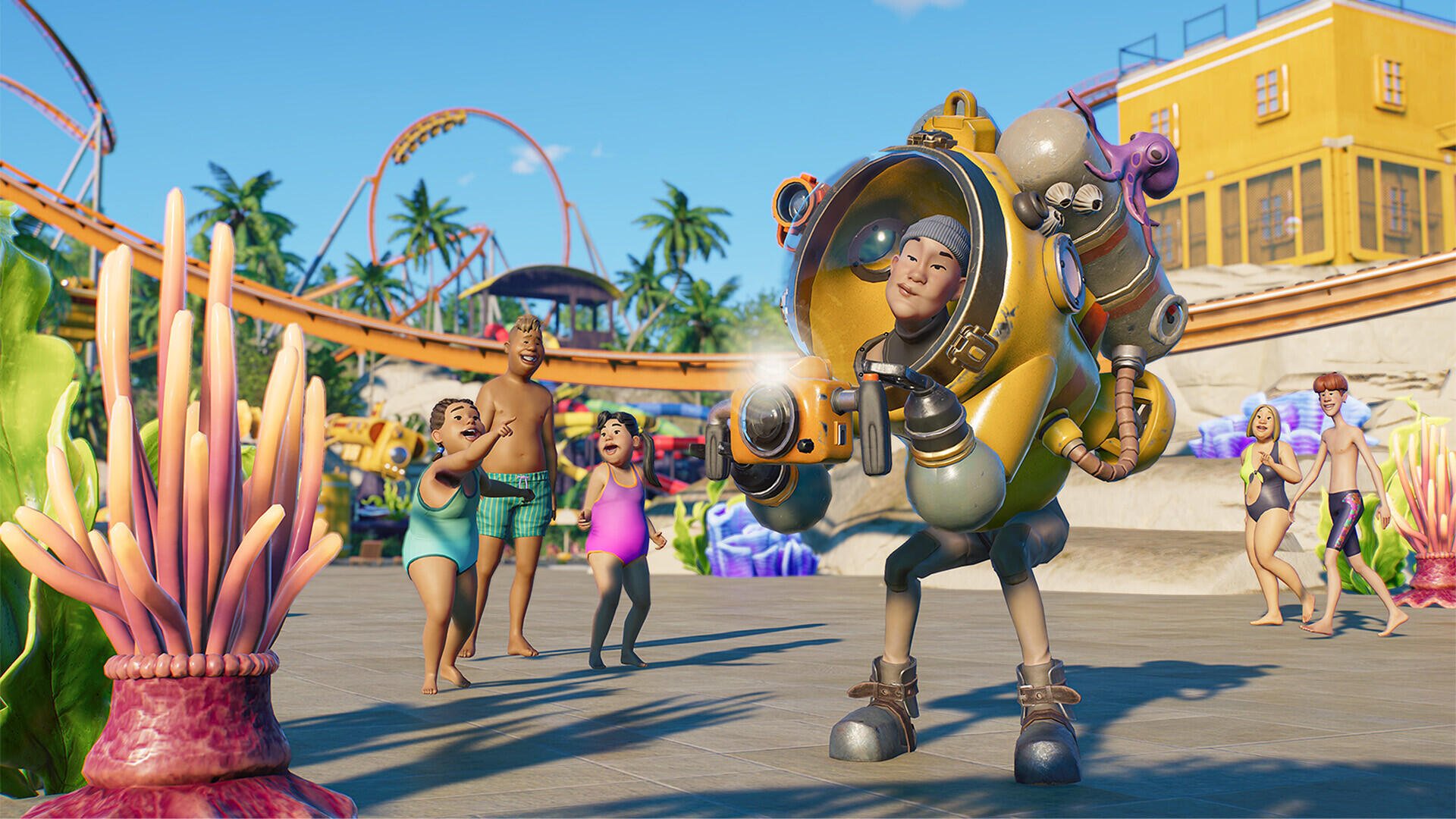 HD desktop wallpaper from the video game Planet Coaster 2, featuring a cheerful character in a futuristic suit with a roller coaster and crowd in the background.