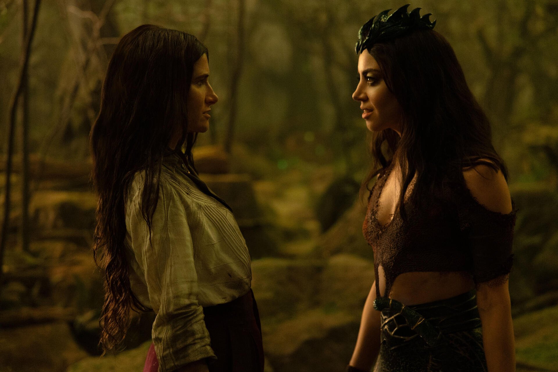 A scene from the TV show Agatha All Along, featuring two characters in a forest, showcasing tension between them. This image serves as a 4K Ultra HD desktop wallpaper.