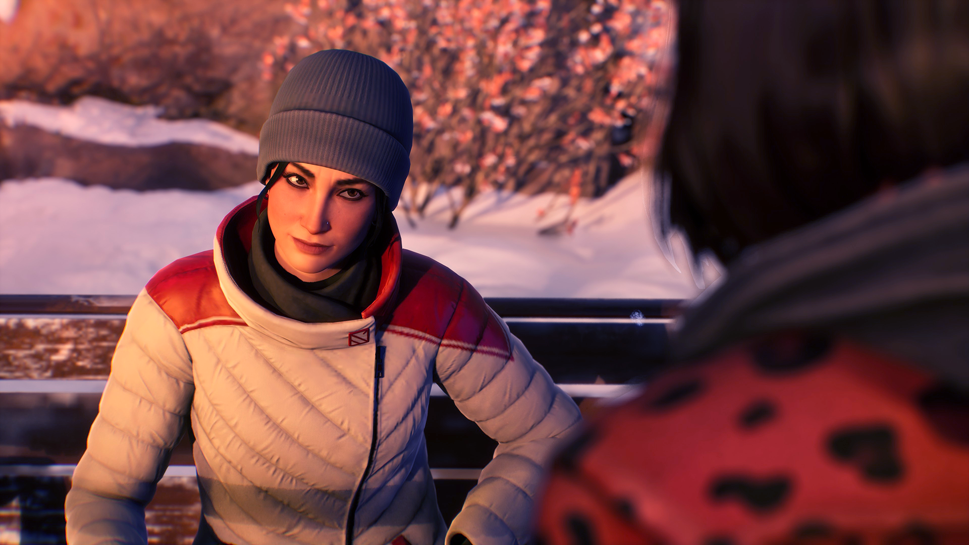 A scene from the video game Life is Strange: Double Exposure, featuring a character in a cozy winter outfit, set against a snowy backdrop. This HD wallpaper captures emotional dialogue and atmosphere.