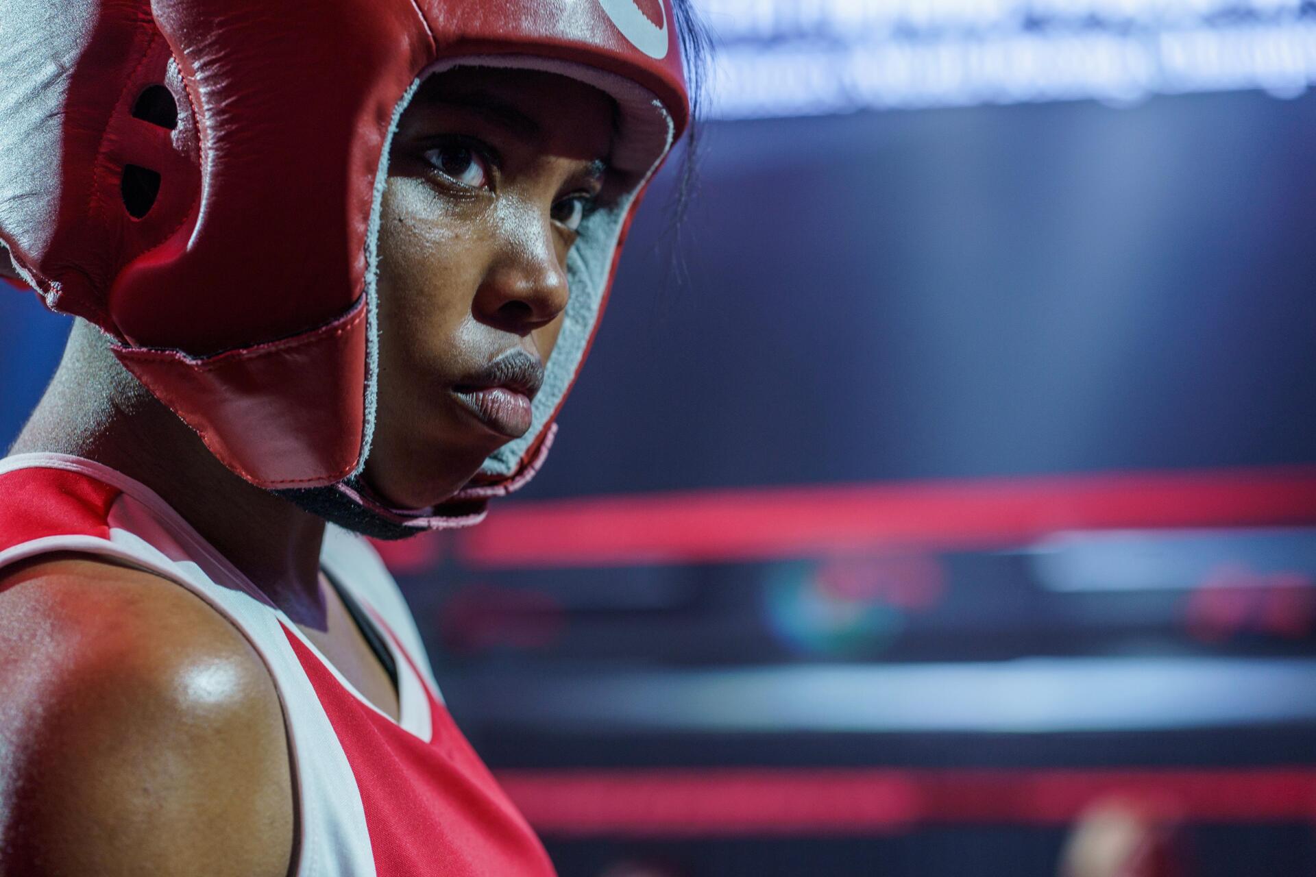 A striking image from the movie The Fire Inside, featuring Ryan Destiny in a boxing helmet, showcasing determination in a vibrant, competitive setting. 4K Ultra HD quality.