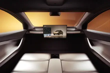 Interior view of a Tesla robotaxi, featuring sleek leather seating and a modern dashboard screen, showcased in an 8K Ultra HD desktop wallpaper, emphasizing the Cybercab design.