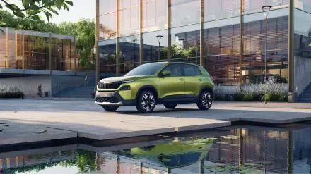 A Škoda Kylaq parked by a modern building, reflecting in a serene pool. This vibrant green SUV captures attention in this 4K Ultra HD desktop wallpaper.