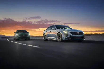 A stunning 8K Ultra HD desktop wallpaper featuring two Cadillac CT5-V Blackwing cars on a scenic road at sunset, highlighting their sleek design and powerful presence.