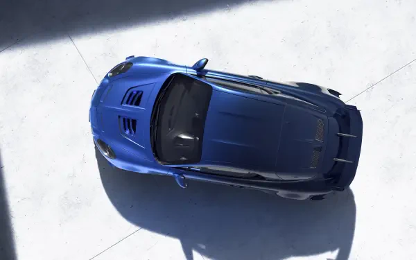 An overhead view of a striking blue Alpine A110 R Ultime, showcased in a clean, modern setting, captured in stunning 4K Ultra HD resolution for a dynamic desktop wallpaper.