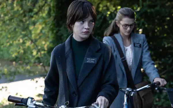 Sophie Thatcher in a scene from the 2024 movie Heretic, depicting two characters on bicycles amid a lush, green background, captured in stunning 4K Ultra HD.