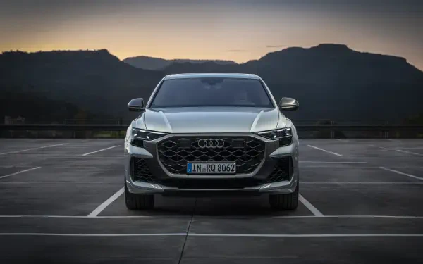 Audi RS Q8 parked in an empty lot, with mountains in the background during sunset, showcased as a 4K Ultra HD desktop wallpaper.