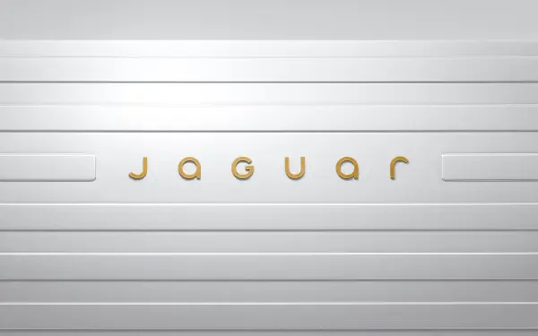 A sleek 4K Ultra HD wallpaper featuring the Jaguar logo, displayed prominently against a clean, modern white background.