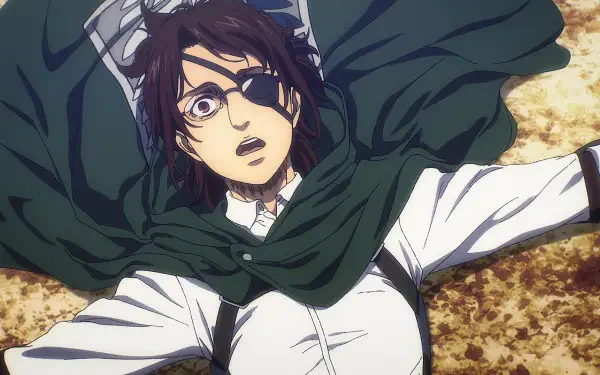 Hange Zoë from Attack on Titan: The Last Attack, portrayed in an emotional moment, lying on the ground with a green cloak draped around them, set against a textured background.