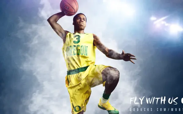 A dynamic HD wallpaper featuring an Oregon Ducks basketball player in a vibrant yellow uniform, capturing the energy and excitement of the game.