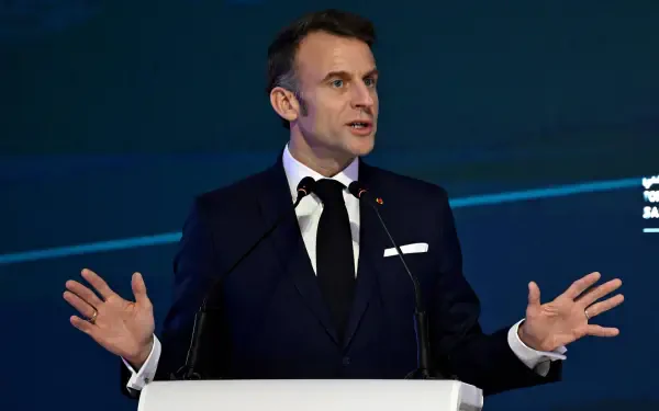 Emmanuel Macron speaks confidently at a podium, dressed in a formal suit, against a sophisticated backdrop. This HD image serves as an engaging desktop wallpaper.