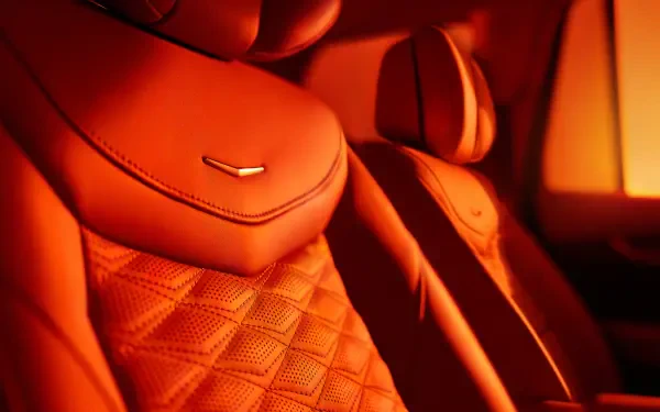 Close-up of luxurious orange leather seats in a Cadillac XT6, showcasing detailed stitching and design. This 4K Ultra HD wallpaper highlights the elegance of automotive interiors.