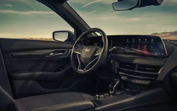 Interior view of a Cadillac CT5-V Blackwing, showcasing a sleek dashboard and premium materials, perfect for an 8K Ultra HD PC desktop wallpaper.