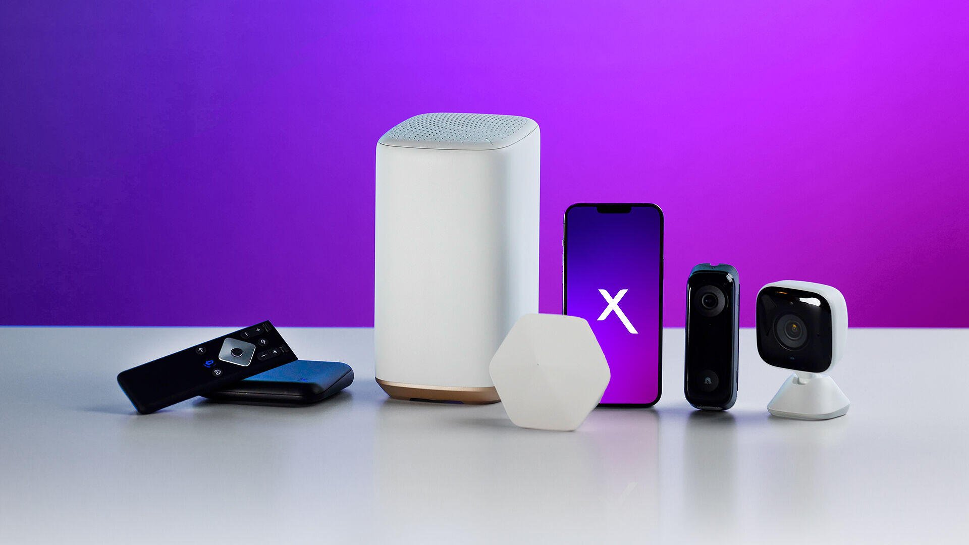 A modern desktop wallpaper featuring Xfinity technology products, including a router, smartphone, and smart devices, set against a vibrant purple backdrop.