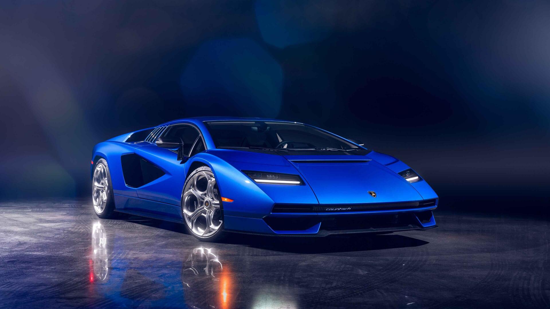 A sleek blue Lamborghini sports car showcased in 4K Ultra HD, highlighting its sharp design and glossy finish against a dark, reflective background.