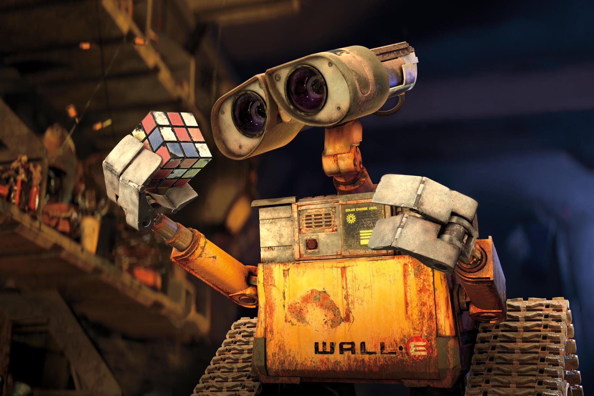Wall·E, the beloved character from Pixar, holds a Rubik's Cube in this HD desktop wallpaper, showcasing his charming and curious personality against a detailed background.