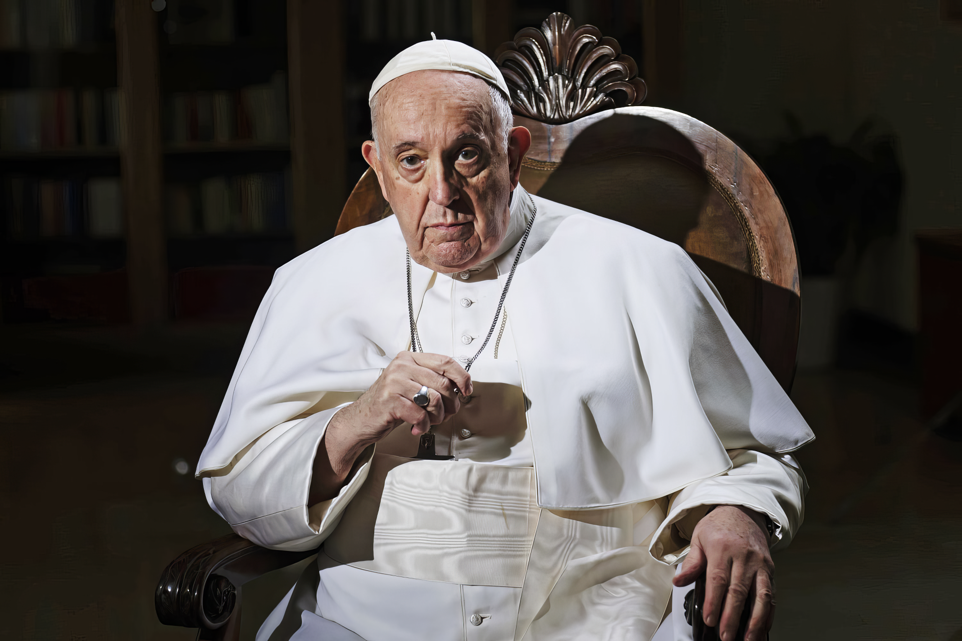 Pope Francis seated in a chair, wearing traditional papal attire, with a serious expression. This image serves as a striking HD desktop wallpaper and background.