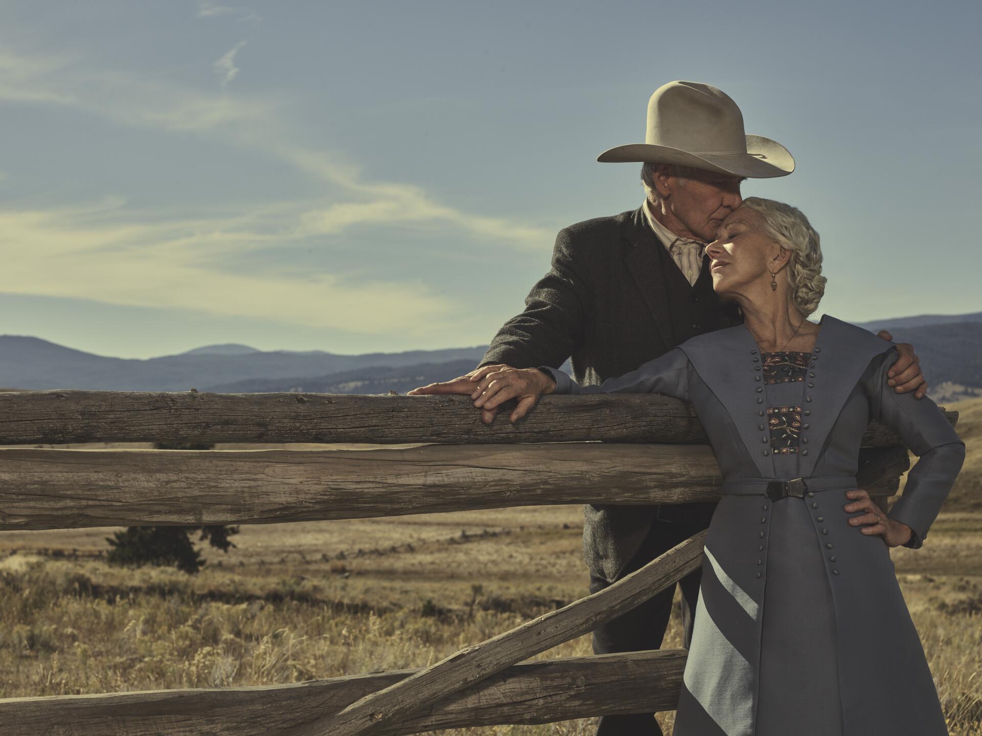 A scenic 8K Ultra HD wallpaper featuring Helen Mirren and Harrison Ford from the TV show 1923, set against a vast rural landscape with mountains in the background.