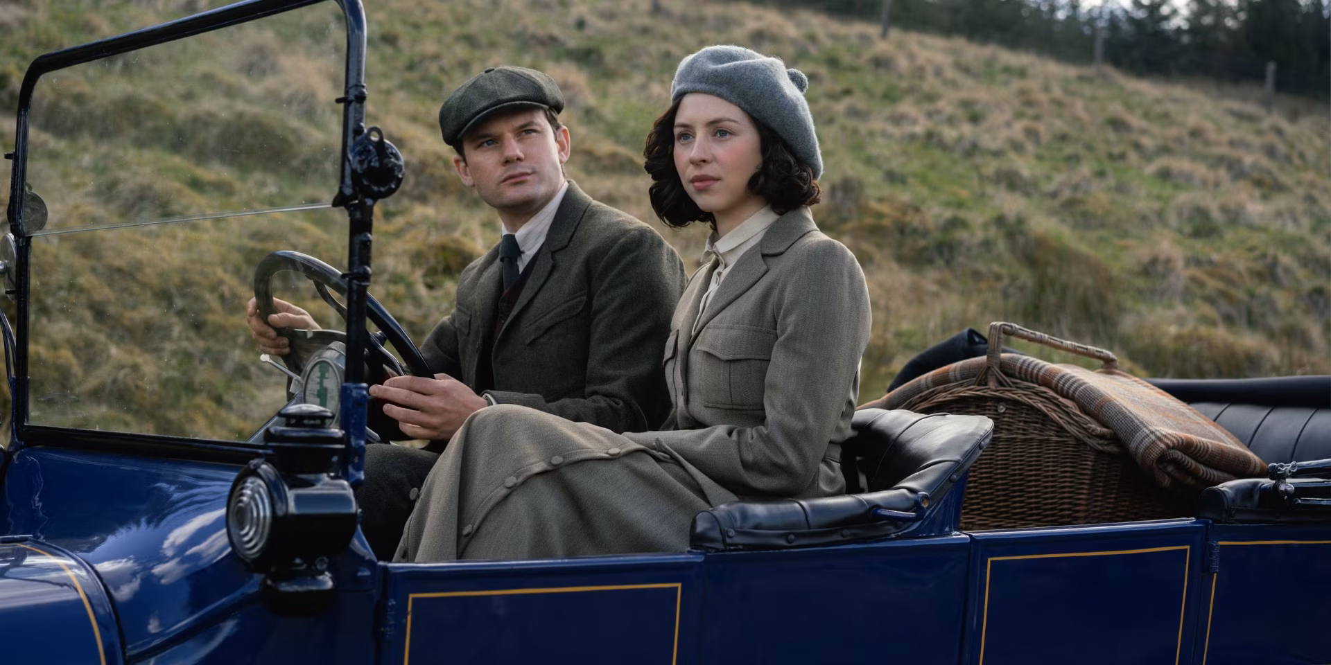 HD desktop wallpaper featuring a scene from the TV show Outlander: Blood of My Blood, depicting two characters dressed in period attire seated in a vintage car.