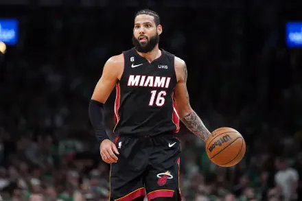 Caleb Martin of the Miami Heat dribbles the basketball during an NBA game, showcasing his skills in this vibrant 4K Ultra HD desktop wallpaper.